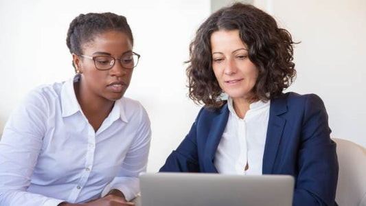 Enneagram Coaching Programme for ACTIVE© Leadership: Two professionals collaborating at a laptop, symbolising insightful leadership coaching.
