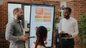 People standing around board looking at analytics