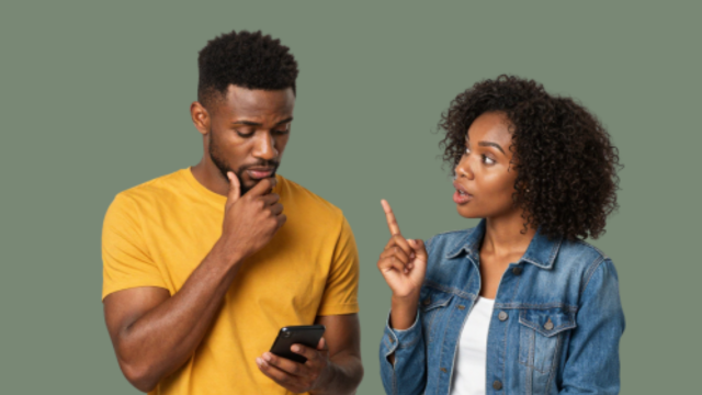 Two people - man in yellow short looking down on phone with hand on chin, lady on his left pointing finger at him - talking