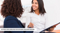 Image of two women sitting down, shaking hands