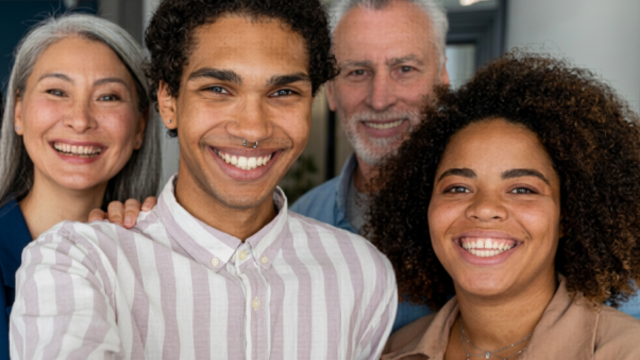 Group of people looking into camera smiling