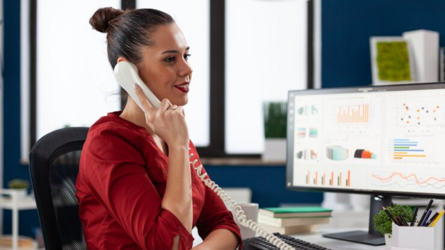 Young woman in a red shirt on the telephone